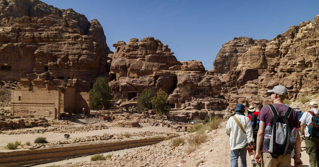 Group walking and looking out to a ruin in Petra, Jordan